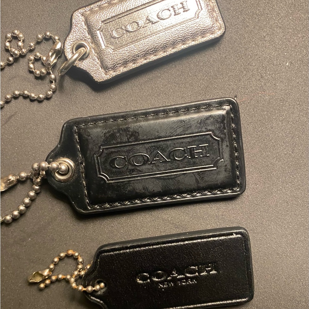 Coach leather tags. 2 black and one silver.